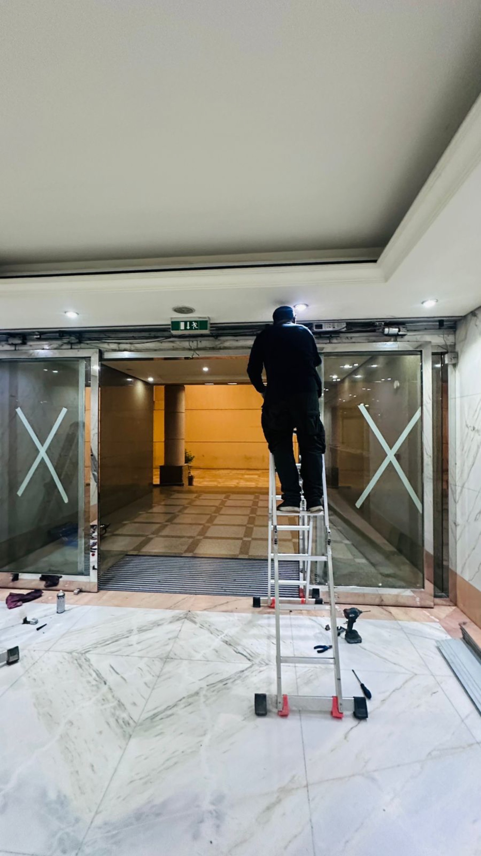 Automatic sliding glass door installation at Dubai commercial building entrance