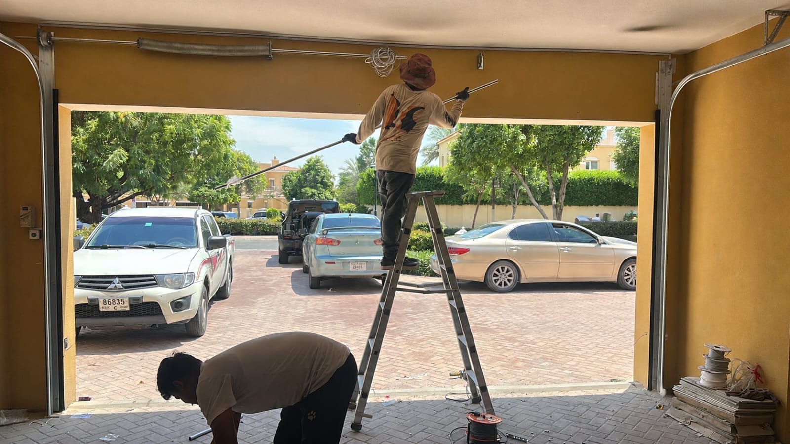 Credible Automation technicians preparing garage door installation in Dubai villa community