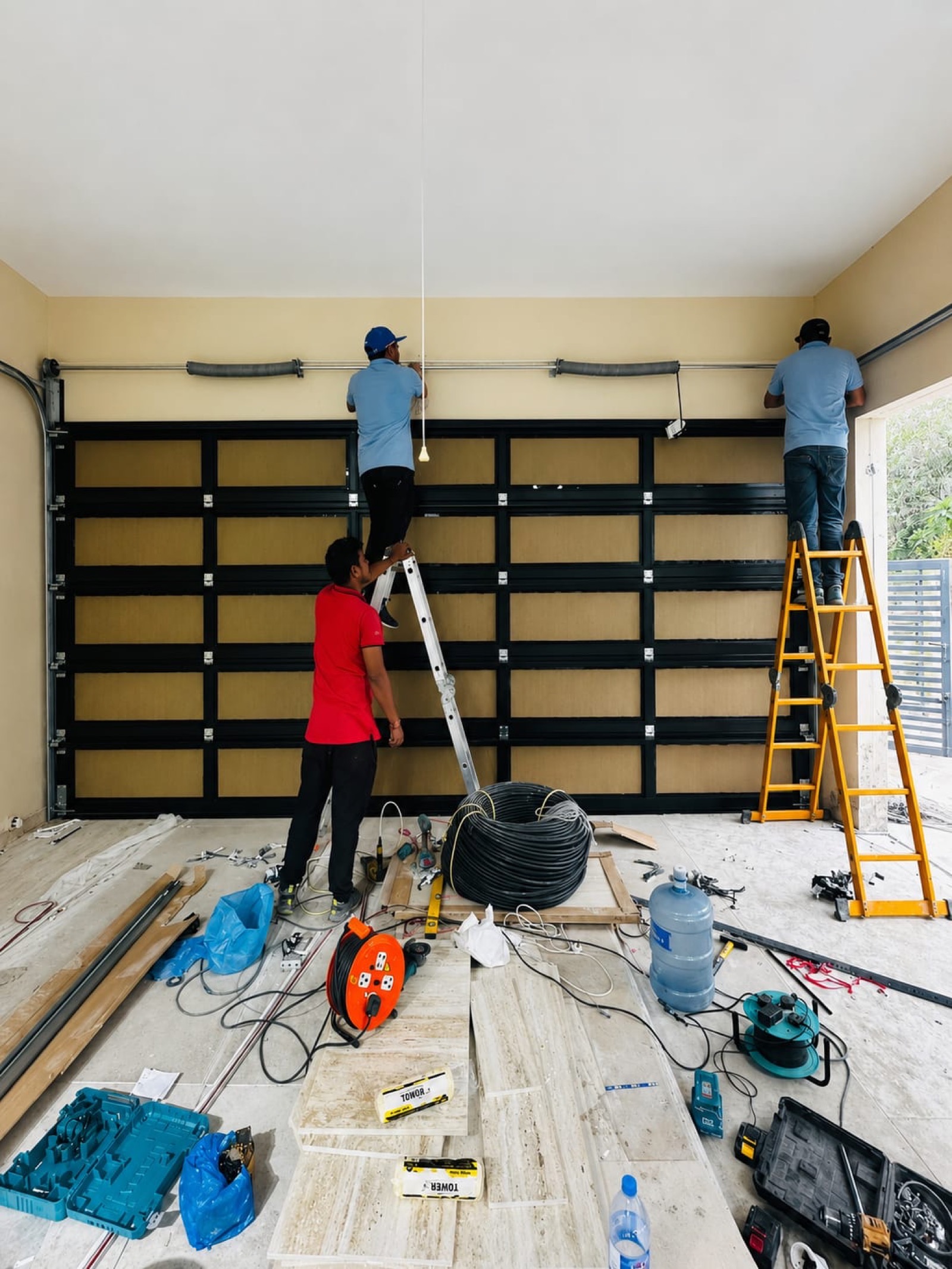 Credible Automation team installing sectional garage door in a Dubai villa