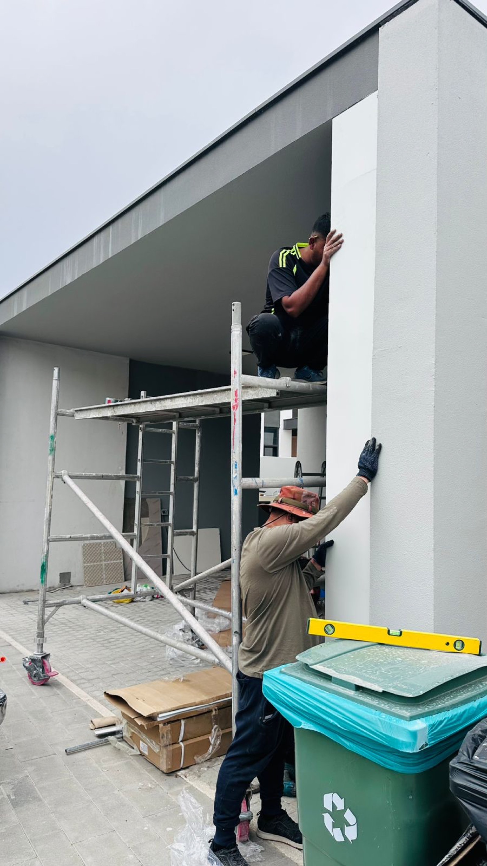 Team installing garage door header at modern Dubai villa