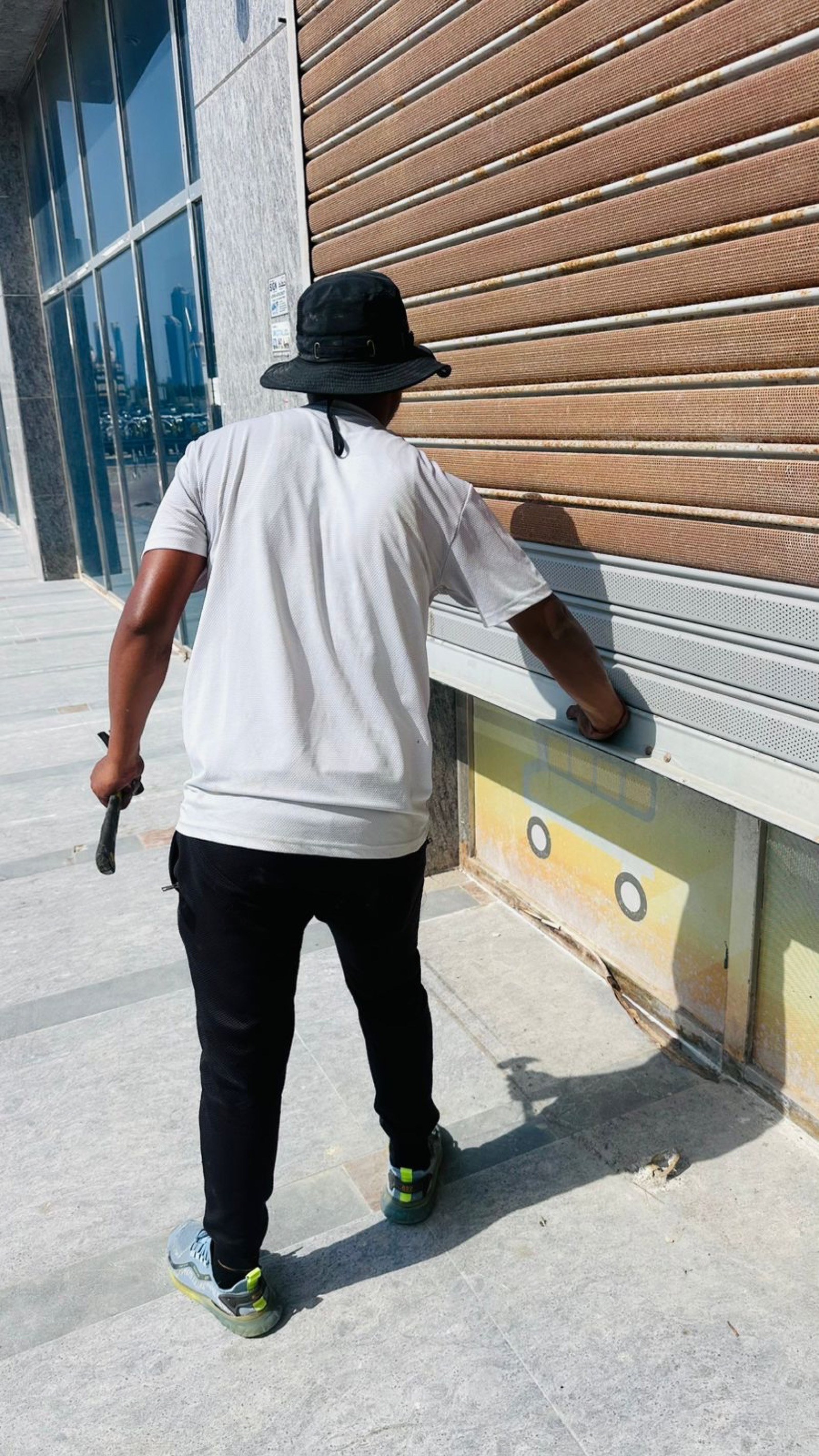 Credible Automation technician servicing rolling shutter at Dubai commercial premises