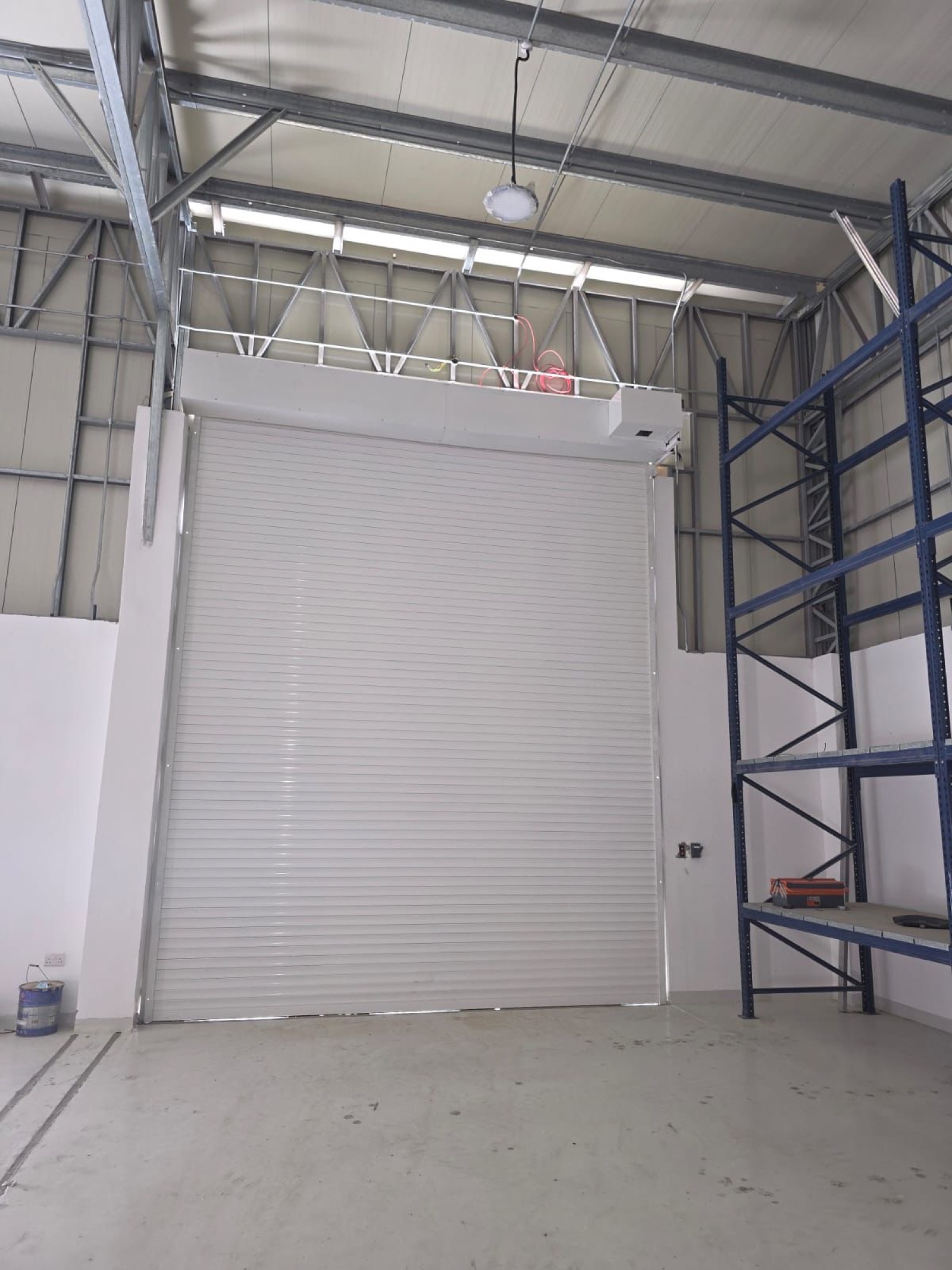 Completed white heavy-duty rolling shutter at Dubai warehouse